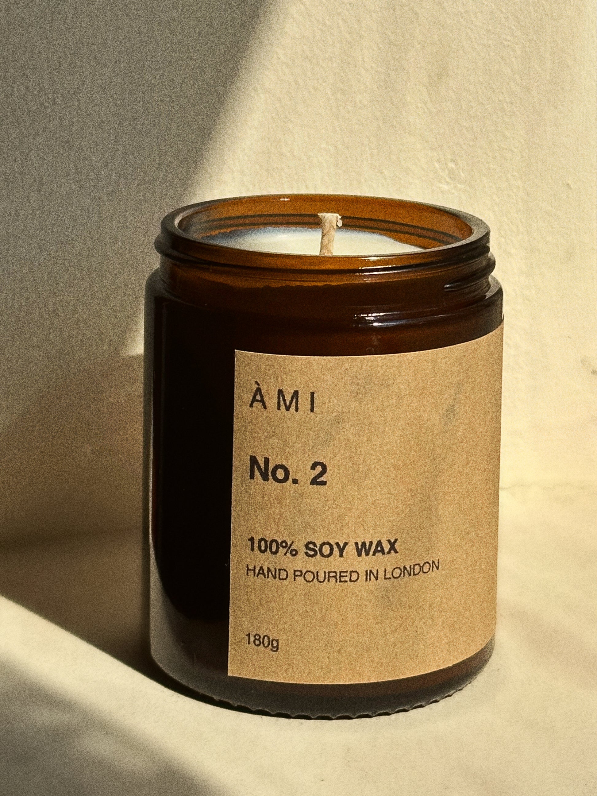Scented soy wax candle in a glass jar with a flickering flame, surrounded by orange, lemon slices, and sprigs of lavender and jasmine, creating a calming and luxurious ambiance







