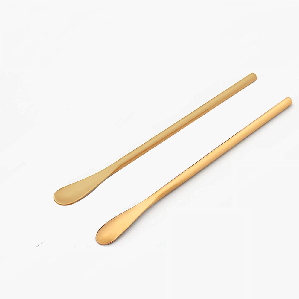 Gold stainless steel skincare spatula for hygienic and precise application of moisturisers and clay masks by AMI London.